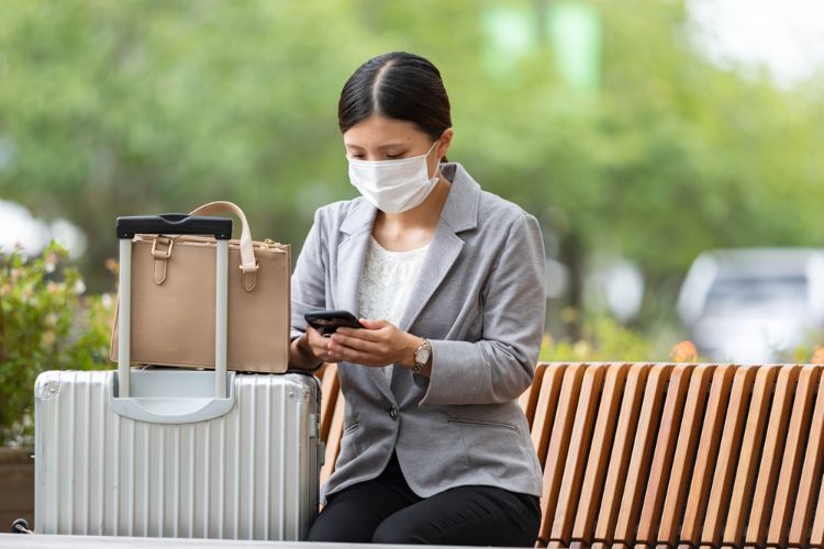 Woman traveling for work with mask