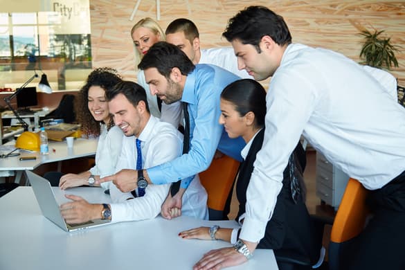 business people huddled around a desk working together