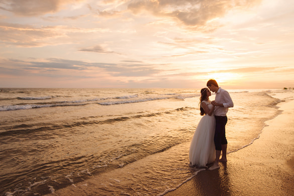 a couple kiss at sunset on the beach