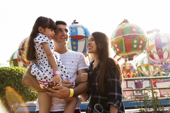 a family smiles while they enjoy a carnival in florida