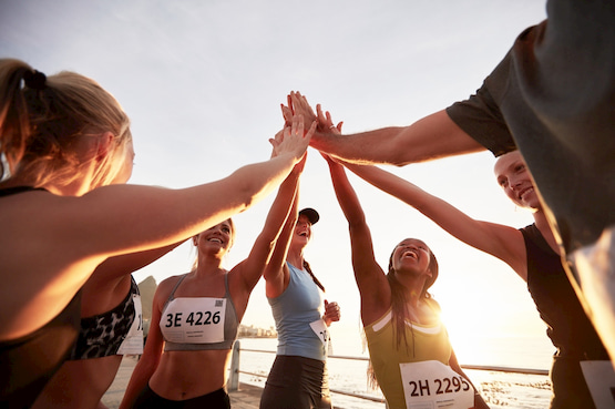 a group of runner high-five in Tampa